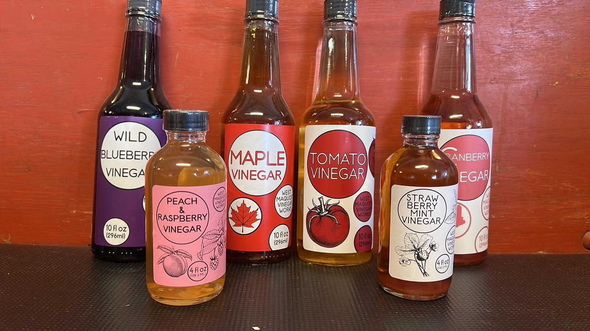 West Maquoit Vinegar Works bottles including Wild Blueberry, Maple, Tomato, Strawberry Mint, Peach and Raspberry, and Cranberry vinegars